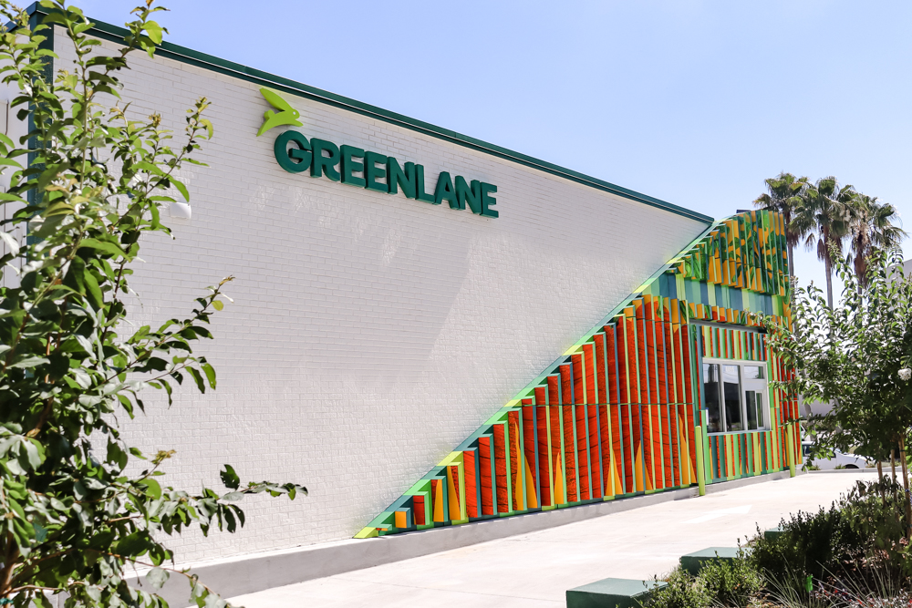 GREENLANE Logo Signage Shot Exterior wall sign with greenery