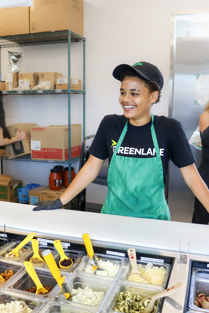 GREENLANE Bowl Assembly Photography Employee preparing bowl at salad bar