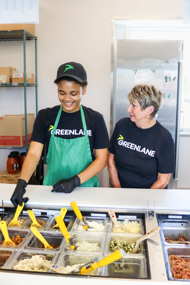 Staff Culture Photo – GREENLANE Tampa Two team members in GREENLANE uniforms smiling