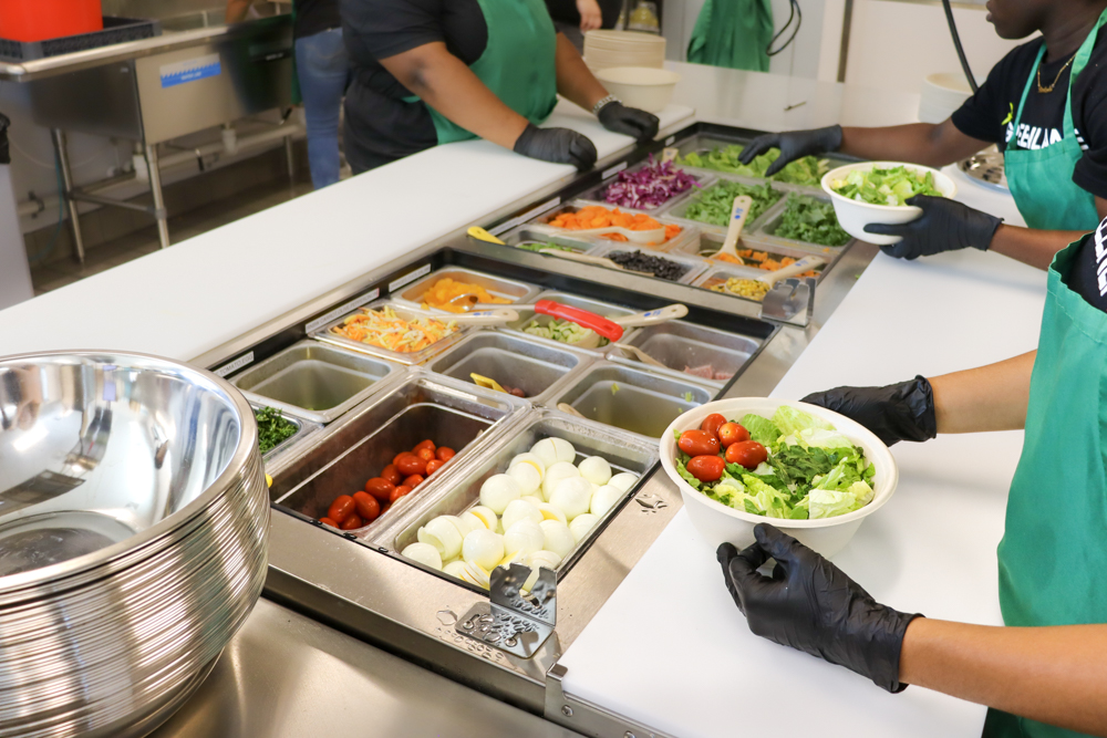 GREENLANE Kitchen Branding Shot Staff members working prep line in uniform