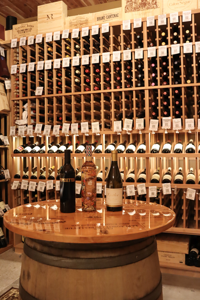 Store Interior Wine Wall Photography Wide shot of wine wall and floor-to-ceiling shelves