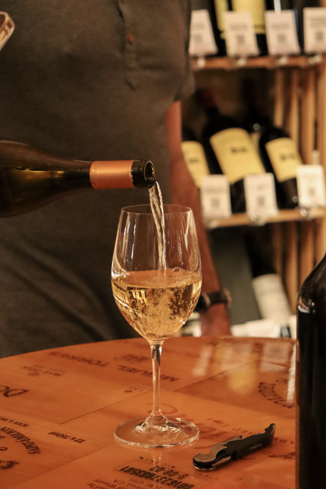 In-Store Wine Tasting Event – Staff Focus Male staff member pouring at tasting counter