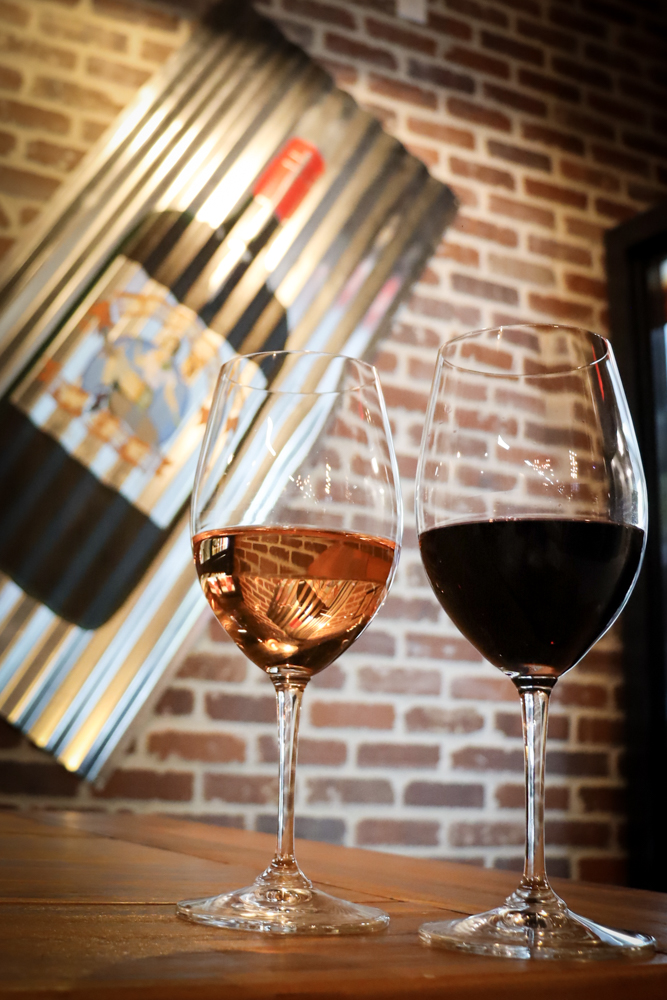 Wine Glass Product Display – Tampa Wine Shop Glasses of red and rosé wine on countertop