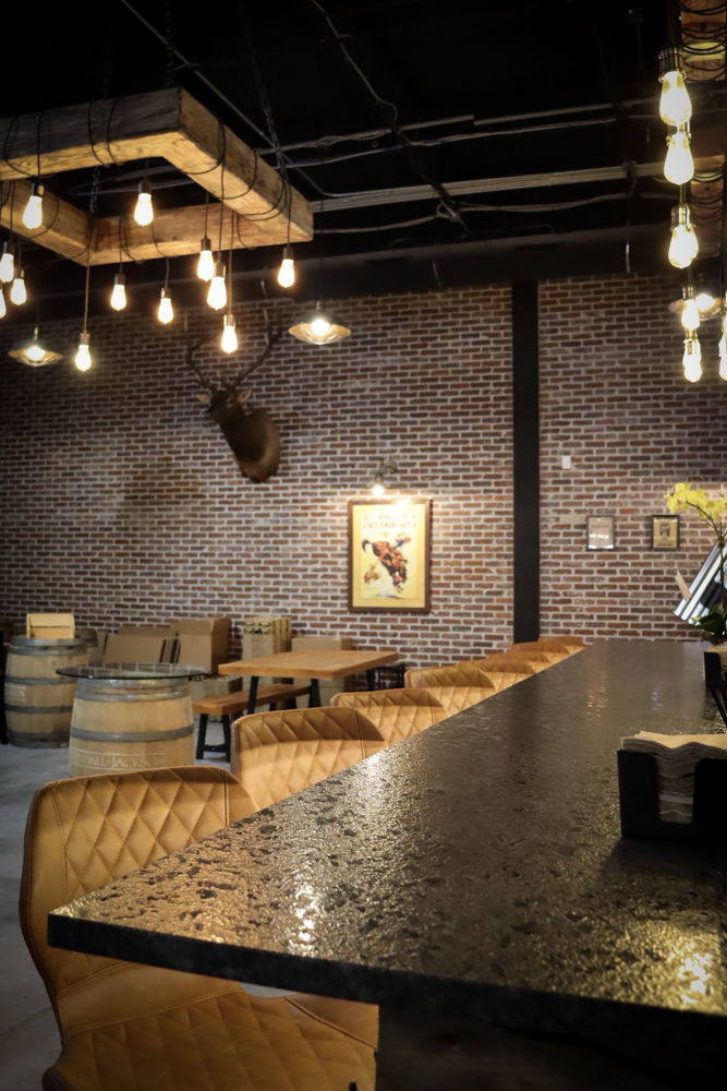 Wine Tasting Counter – Interior Photography Tampa Bar counter with hanging lights and wine bottle setup