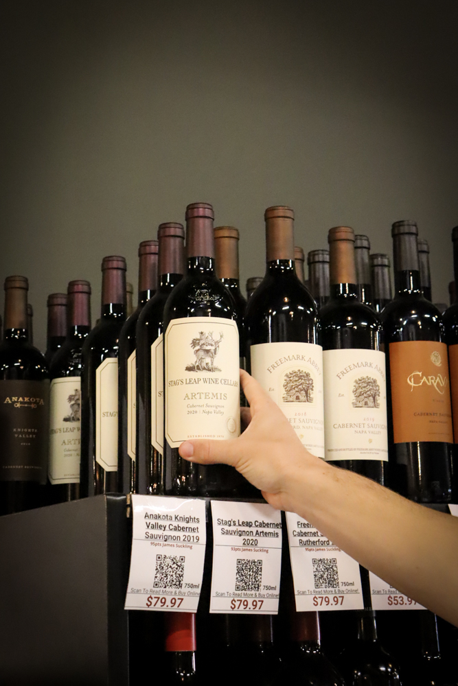 Sparkling Wine Product Display – Tampa Wine Shop Red wine bottle lineup on retail shelf