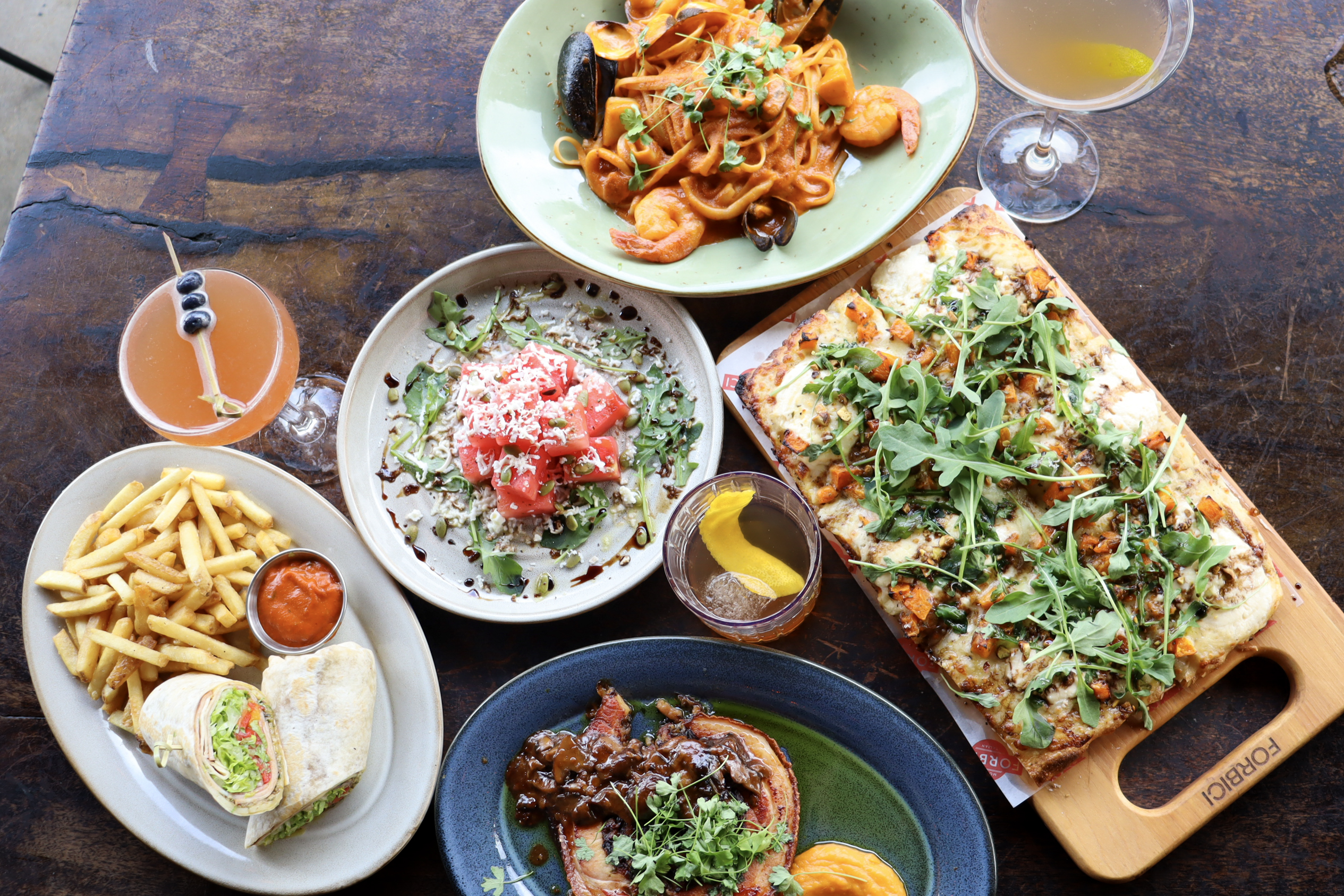 Restaurant Spread Content Tampa Flat lay of cocktails and small plates on wooden table