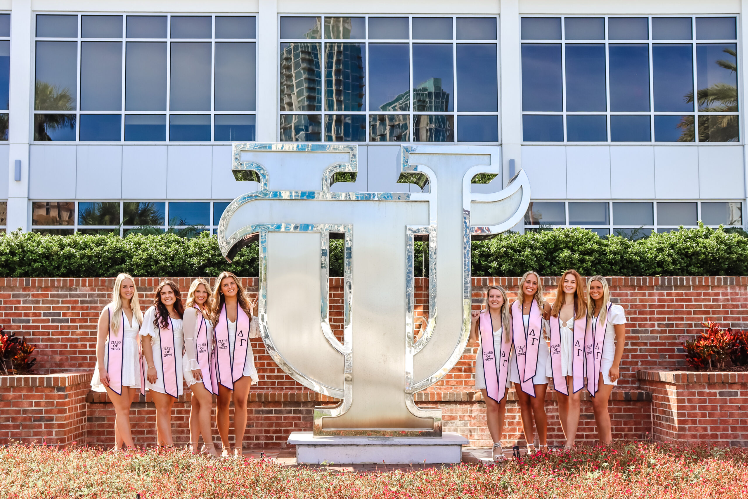 Group of UT grads in front of the University of Tampa sculpture